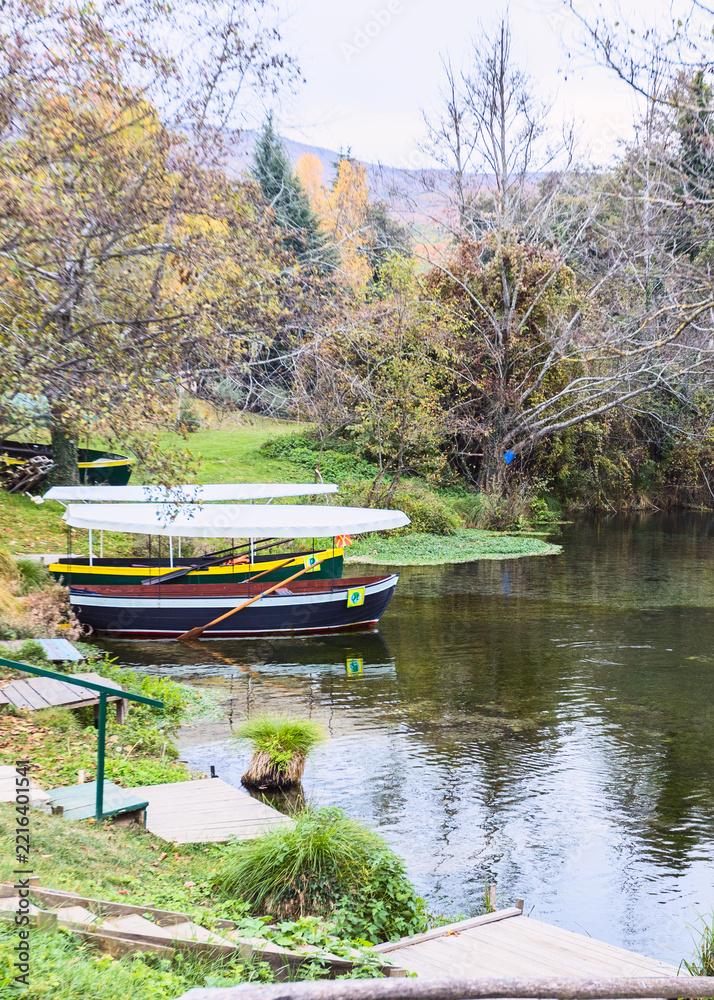 Fototapeta premium Wooden boats on the Black Drin Springs near Saint Naum