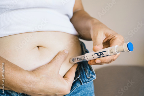 Woman using GLP-1 injection pen as part of weight management treatment