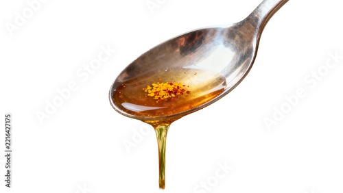 Spoon with honey and turmeric powder, isolated on transparent background