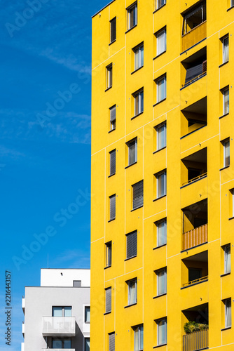 Yellow apartment tower in Vienna Austria with windows and balconies creating contemporary residential architecture around the yellow apartment tower