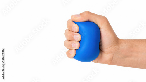 Human hand squeezing a soft blue stress ball toy on a solid background, generated using ai