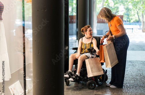 Women with disability enjoying shopping together at store