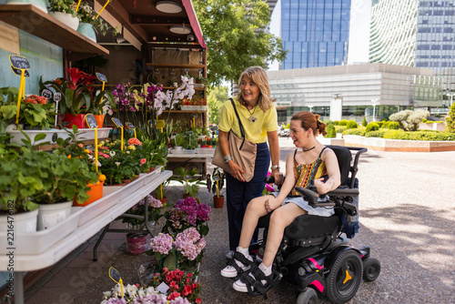 Women shopping for plants at outdoor flower market