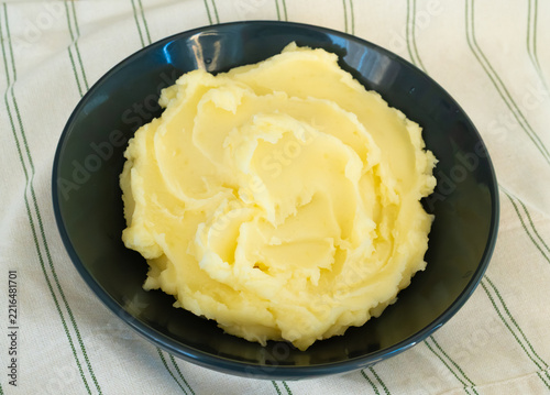 Mash potato in black bowl closeup