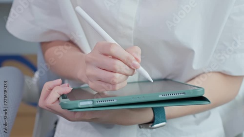 Close Up of Hands Drawing on Digital Tablet with Stylus Pen