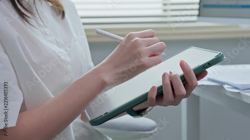 Close Up of Businesswoman Hand Writing with Stylus on Digital Tablet