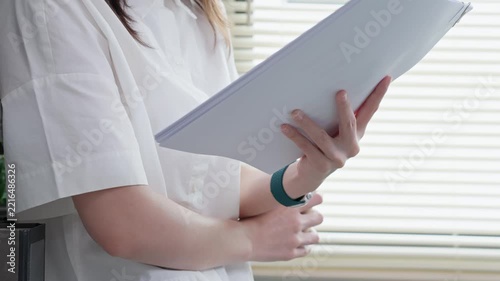 Businesswoman Reading and Reviewing Documents in Office Interior