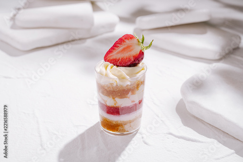 Strawberry trifle dessert shot glass on white background