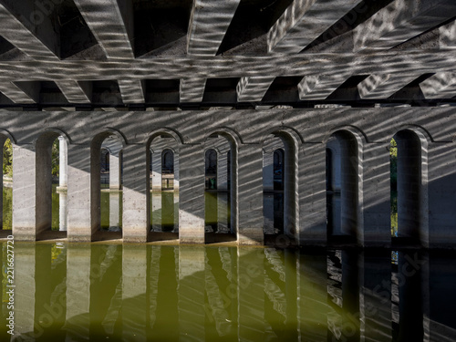 Water reflections of arched bridge construction
