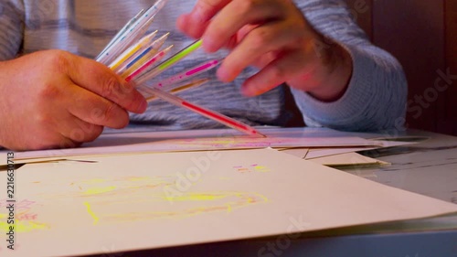 Cinematic Timelapse of Designer Hands Sketching Product Mockup with Colorful Gel Pens Under Desk Lamp Light, Zoom Out Dynamic Shot
