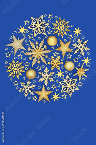 Gold star snowflake bauble tree decorations in circular design on blue background. Luxury abstract festive arrangement for greeting card, gift tag logo.