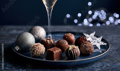 Holiday chocolates arranged with star-shaped ornament on dark plate