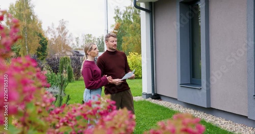 Real estate agent showing modern house to client. Realtor and customer inspecting property before buying
