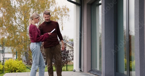 Real estate agent showing modern house to client. Realtor and customer inspecting property before buying