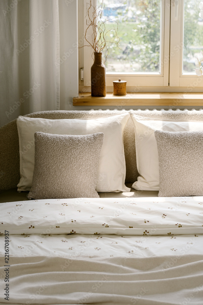 Fototapeta premium Bedroom interior with pillows and white bedding on bed