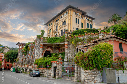 Beautiful villa with stylish facade surrounded by green decorative plants near Portofino. Liguria, Italy