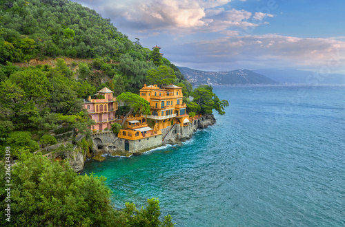 View of colorful houses over turquoise water on the coast in Portofino. Liguria, Italy