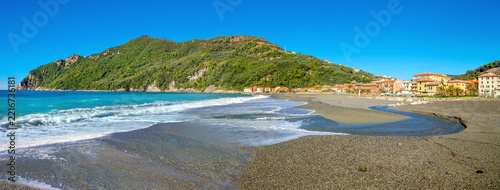 View of sandy beach and coastal residential  district in Sestri Levante resort town. Liguria, Italy