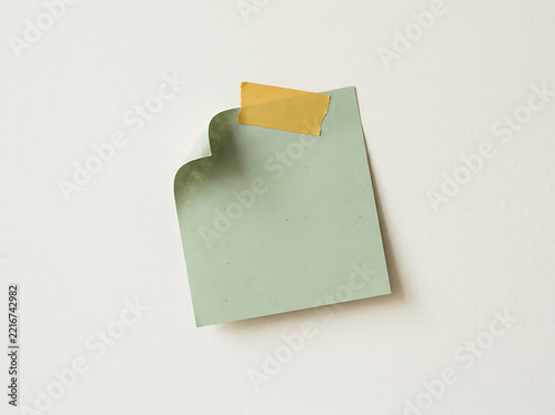 Light green sticky note with yellow tape
