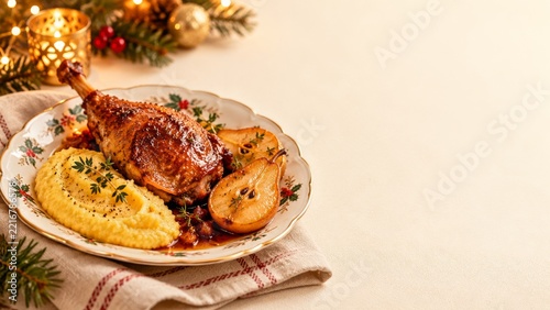Roasted goose leg with pear halves and polenta on a cream table