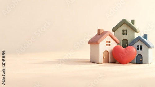 Three Pastel Clay Houses with a Coral Heart Against a Warm Cream Backdrop