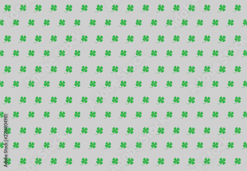Green clover leaves on a gray background for the background. Clover leaves for the background.