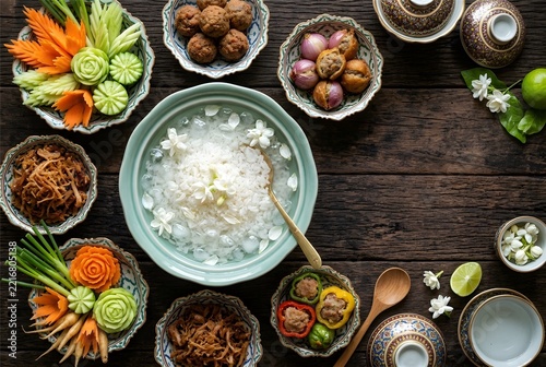 Traditional Thai food Khao Chae rice in iced jasmine water with side dishes, top view