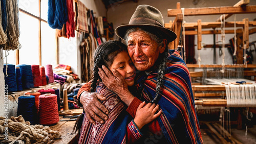 Elderly indigenous woman and young girl hugging in traditional