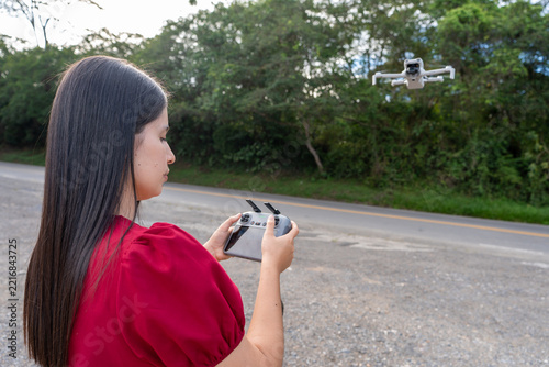 A young woman operates a professional drone used for photography and video
