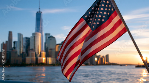 New York City skyline and American flag over calm water at sunset, dramatic clouds, Patriot Day remembrance and memorial, with copy space