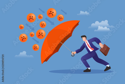 Man shielding himself with an umbrella from bad mood emojis and critical arrows. Creative concept of mental strength, emotional balance, overcoming depression, and positive attitude at work.