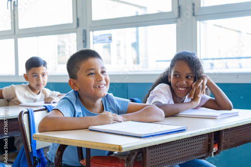 Primary school students learning and enjoying in classroom