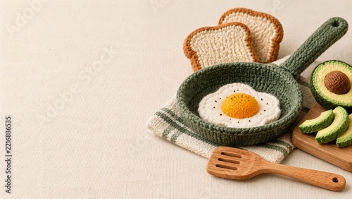 Knitted Breakfast Scene with a Fried Egg and Avocado in a Green Pan