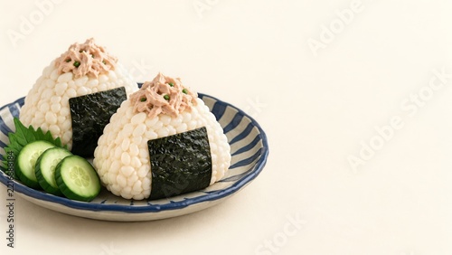 Clay Style Tuna Rice Balls with Seaweed Bands and Cucumber on Blue Plate