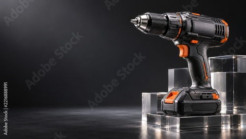 Black and Orange Cordless Drill on Clear Acrylic Blocks with Dark Copy Space