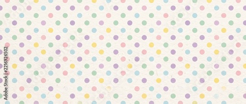 Pastel polka dot paper texture background. Colorful spotted pattern on off-white craft paper for Easter wrapping and invitation design