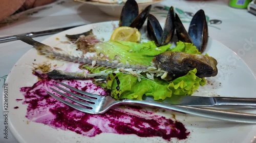 Seafood Leftovers on Used Plate at Restaurant Table