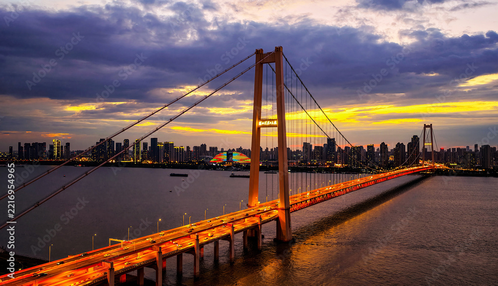 Fototapeta premium Illuminated Yangsigang Bridge Over Yangtze River in Wuhan at Evening