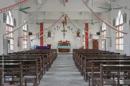 Simple Christian Church Interior with Wooden Pews and Festive Decorations in Dongxing, China