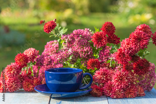 Afternoon tea in the blooming garden by sunny day