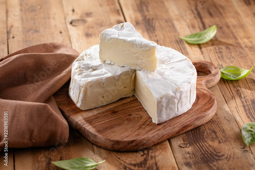 Fresh Brie cheese with herbs. Camembert cheese.