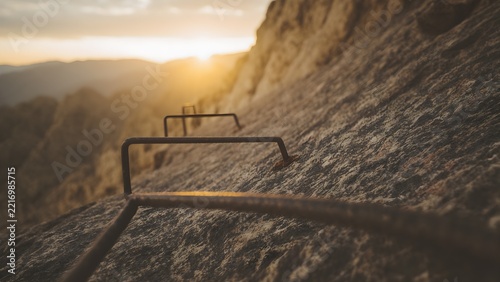 Steel cable and iron rungs on a cliff face, via ferrata route
