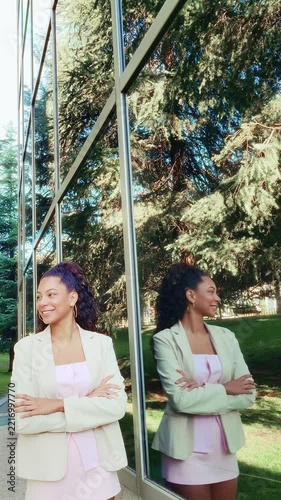 Confident businesswoman smiling outside corporate building