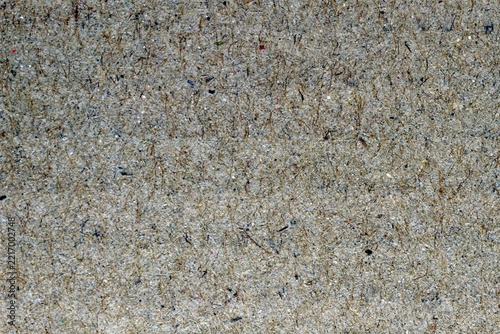 Texture of gray recycled cardboard with a fibrous and rough surface.