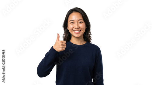 Young Asian woman with thumbs up gesture during studio portrait with bright lighting and copy space
