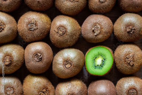 fresh kiwi fruits neatly arranged in a wooden box. Whole organic raw kiwi pattern background, seamless eco friendly food market concept