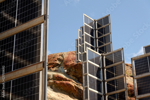 Detail of solar panels in mountains vertically mounted as four wings around central column like tree, photovoltaic plant avoid snow accumulation, future innovation energy concept