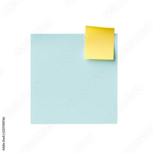 Light blue square paper note with yellow small sticky note attached on white background for office memo planning.