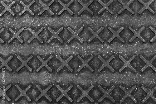 Pattern of metal grate with cross shapes in a grid formation