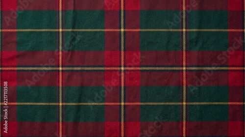 Traditional tartan plaid fabric pattern with red and green checkered lines for winter clothing